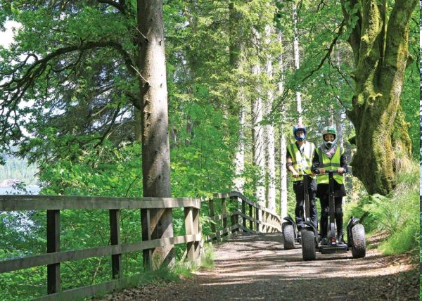 Couple segwaying alongside Kielder Lakeside Way