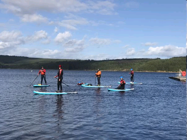 Kielder Water people paddle boarding