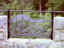 A school of fish swims across Adam Booth's parapet panel. The blacksmiths' designs were inspired by illustrations drawn by Kielder community groups and schoolchildren.